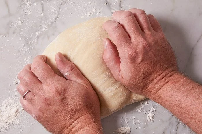hands mixing dough