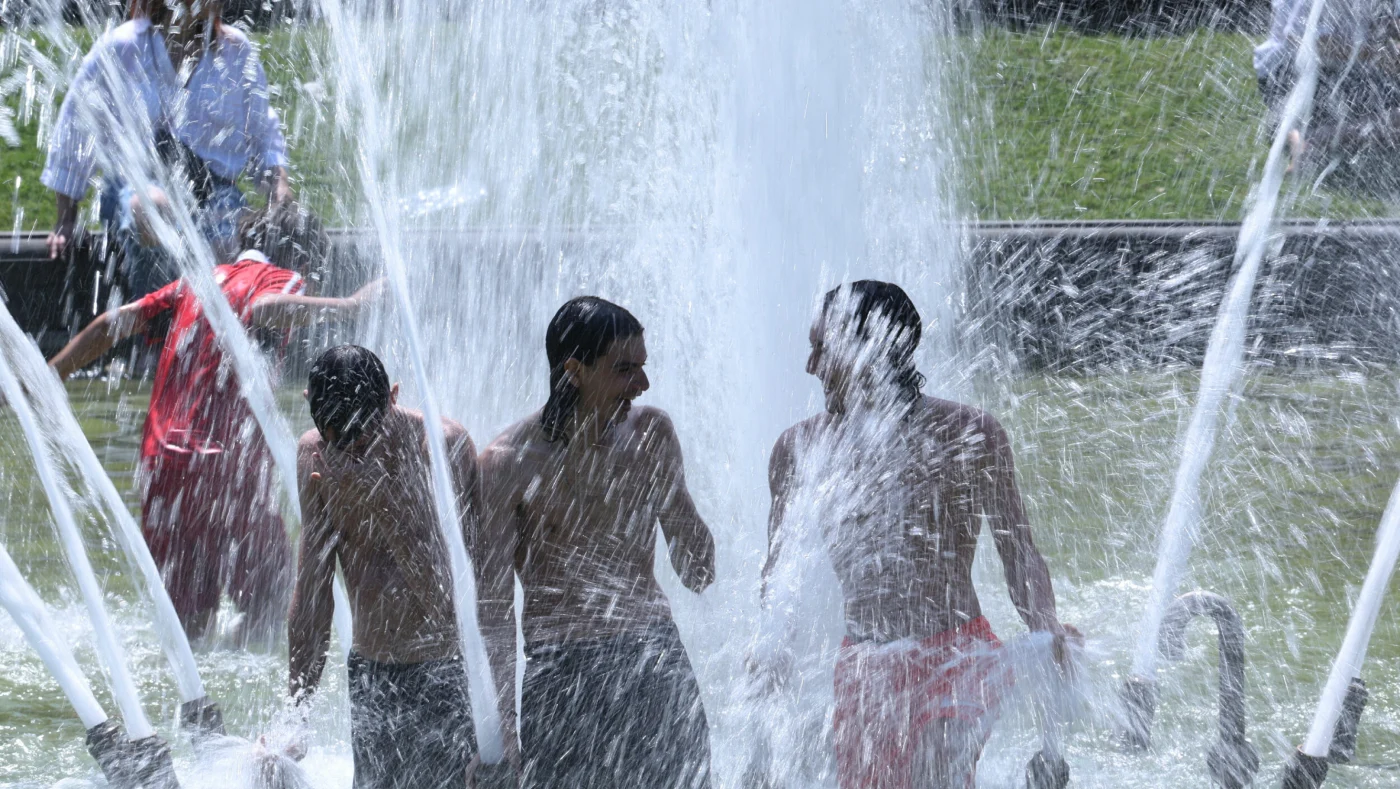 NEDKJØLING: Folk badet i fontener for å kjøle seg ned. Her fra Brussel 25. juni. Foto: Omar Havana / AP / NTB